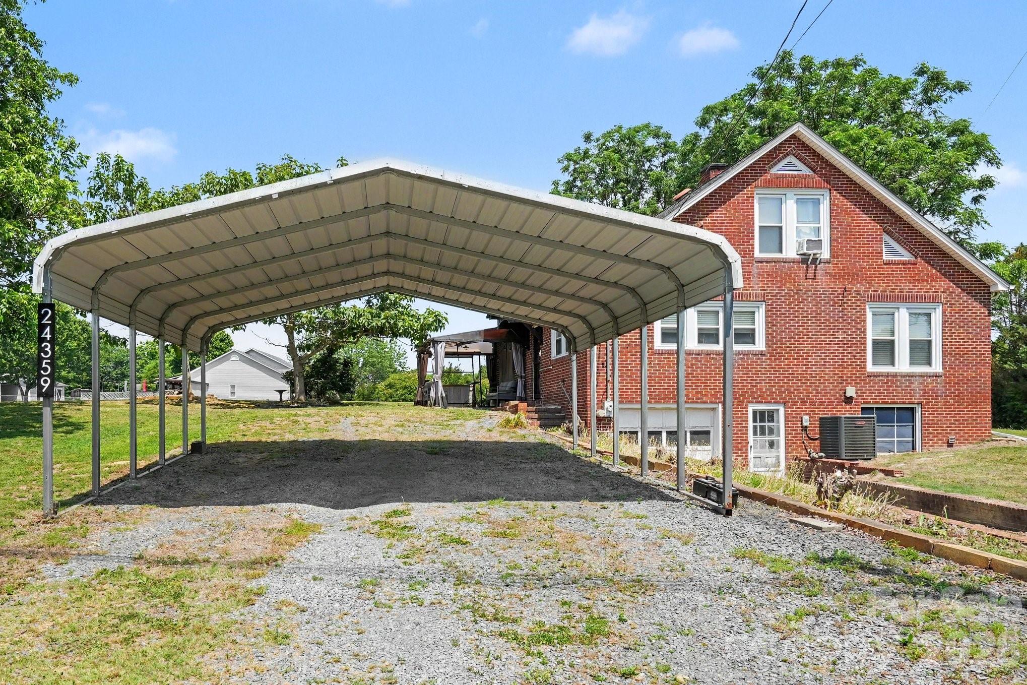 24359 Ridgecrest Road Locust, NC 28097 - Photo 21 of 26 a view of a house with backyard and sitting area