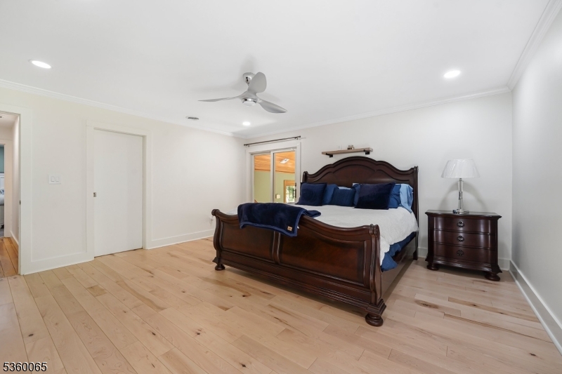 26 Danville Mountain Road Great Meadows, NJ 07838 - Photo 23 of 49 a spacious bedroom with a bed and a chandelier