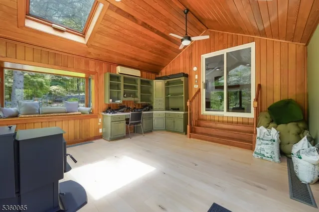 a view of a porch with chairs and potted plants