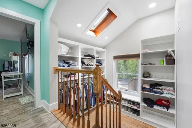 a view of entryway with wooden floor and windows