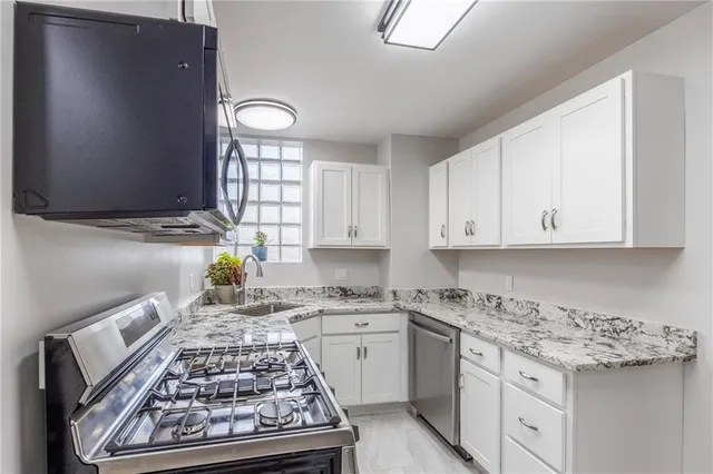 a kitchen with cabinets appliances and a counter top space
