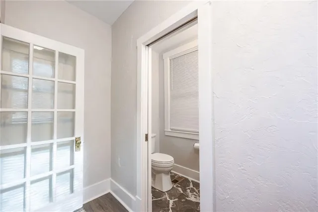 a bathroom with a toilet and a shower