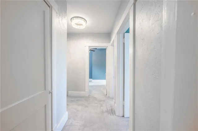 a view of a bathroom from a hallway