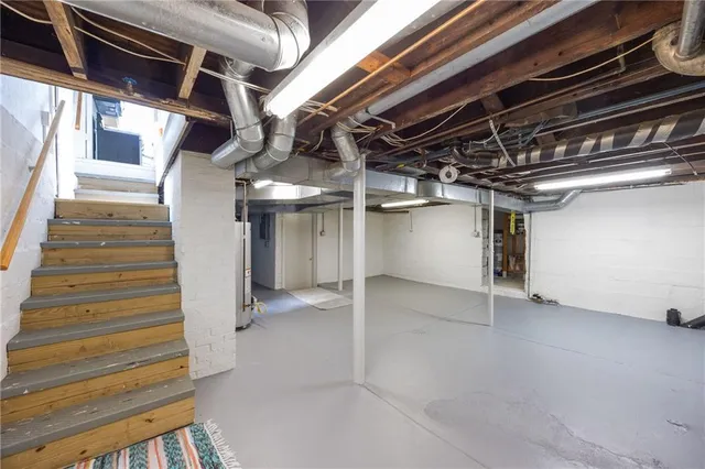 a view of water heater room with staircase