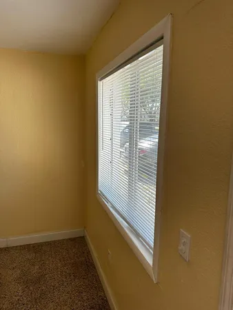 a white refrigerator freezer and a stove sitting inside of a room