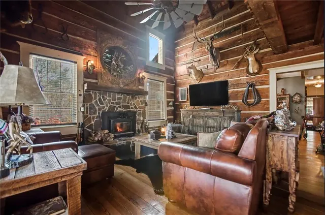 a living room with furniture a flat screen tv and a fireplace