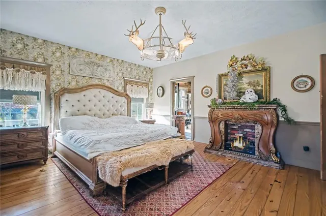 a bedroom with a bed and a fireplace
