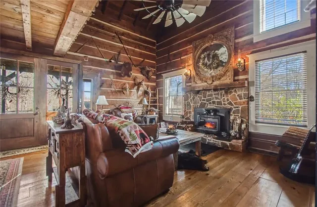 a living room with furniture a fireplace and a window