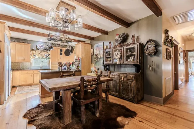 a view of a dining room with furniture and chandelier