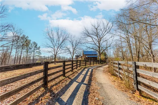 a view of a yard with wooden fence