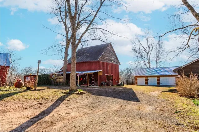 a front view of a house with a yard covered in snow