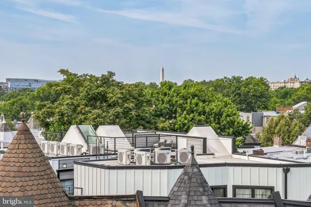 a view of a house with wooden fence