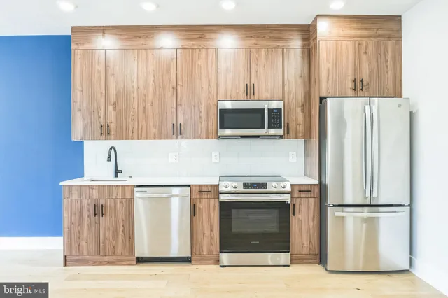 a kitchen with a stove a refrigerator and a sink