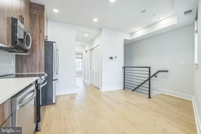 a view of a kitchen with a sink and a refrigerator