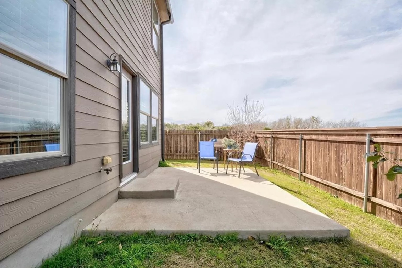 9016 Ridgewell Road Austin, TX 78747 - Photo 26 of 30 Relax on this spacious concrete patio, enclosed by a privacy fence, perfect for outdoor enjoyment.