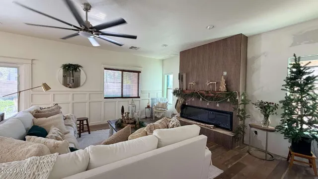 a living room with furniture and a potted plant