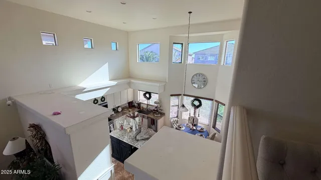 a living room with furniture a potted plant and a wooden floor
