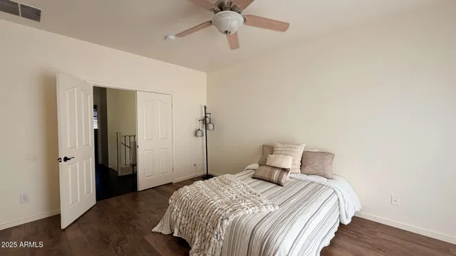 a bedroom with a bed and a ceiling fan