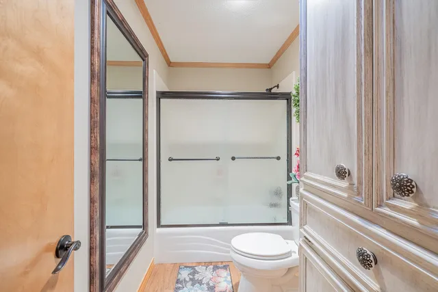 a bathroom with a granite countertop window a toilet and a shower