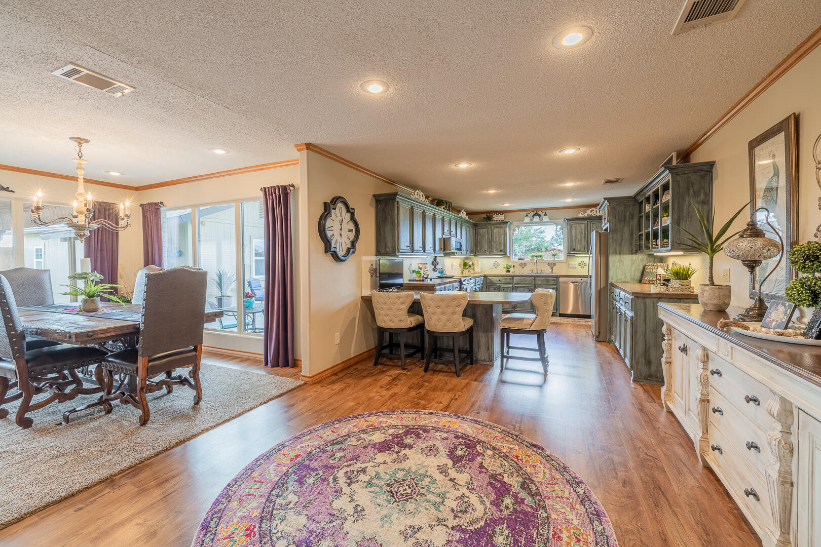 1005 N Avenue South Post, TX 79356 - Photo 25 of 49 a living room with furniture and a dining table with wooden floor