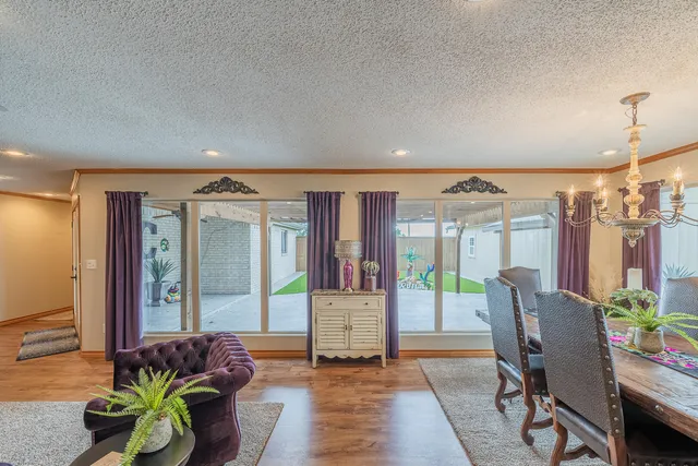 a living room with fireplace furniture and a large window