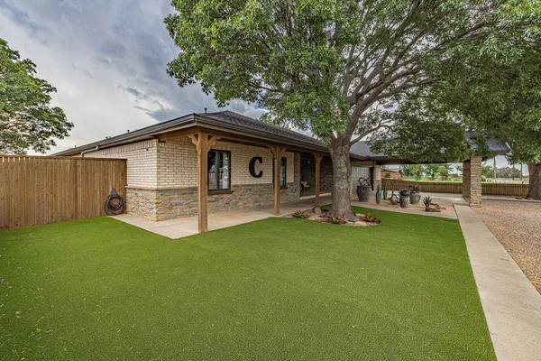 a front view of a house with garden