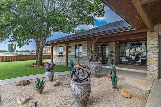 a view of a porch with furniture and garden
