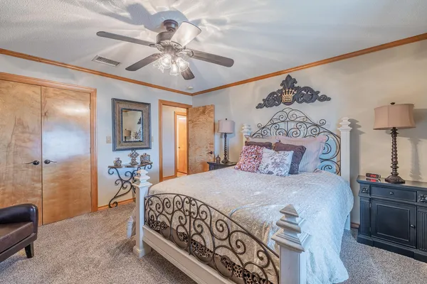 a bedroom with a bed and a chandelier