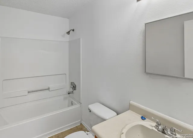 a bathroom with a bathtub and shower