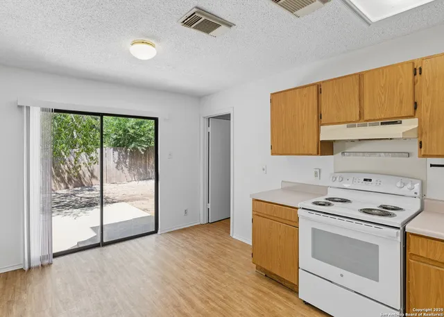a kitchen with a stove a sink and a microwave