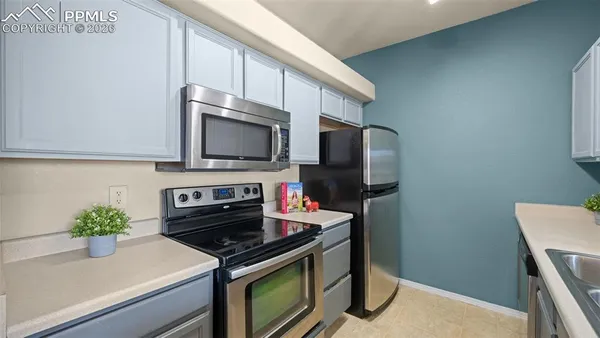 a kitchen that has a sink and a stove top oven