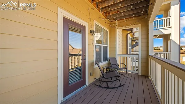 a view of a chairs and table in the balcony