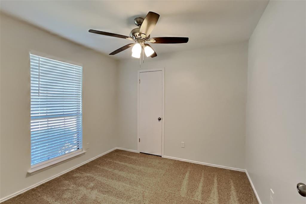 7809 Meadowlark Lane Rowlett, TX 75088 - Photo 13 of 18 an empty room with windows and fan