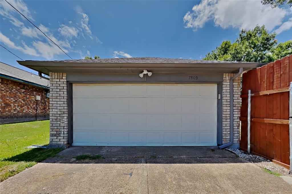 7809 Meadowlark Lane Rowlett, TX 75088 - Photo 16 of 18 a black car parked in front of a house