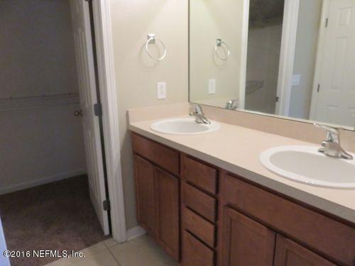 12958 Spring Rain Road Jacksonville, FL 32258 - Photo 11 of 18 a bathroom with a sink and a mirror