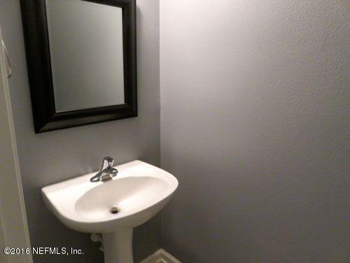12958 Spring Rain Road Jacksonville, FL 32258 - Photo 8 of 18 a bathroom with a sink and a mirror