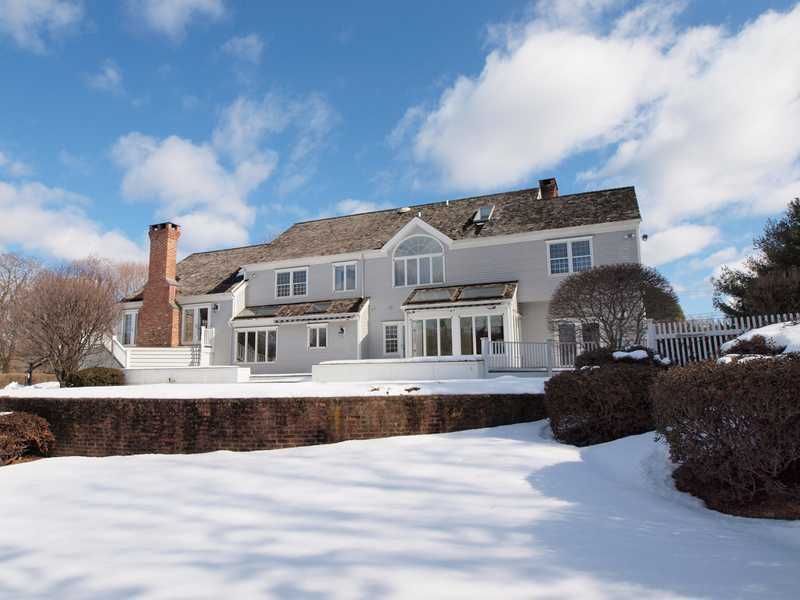 Undisclosed Address Darien, CT 06820 - Photo 2 of 19 a front view of a house with a yard