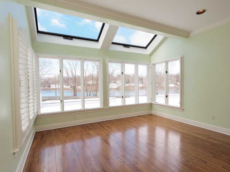 Undisclosed Address Darien, CT 06820 - Photo 11 of 19 a view of an empty room with wooden floor and a window