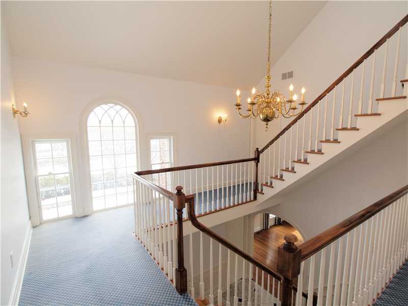 Undisclosed Address Darien, CT 06820 - Photo 12 of 19 a view of staircase with wooden floor and fan