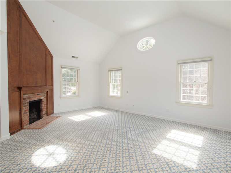 Undisclosed Address Darien, CT 06820 - Photo 15 of 19 a view of an empty room with a window and fireplace