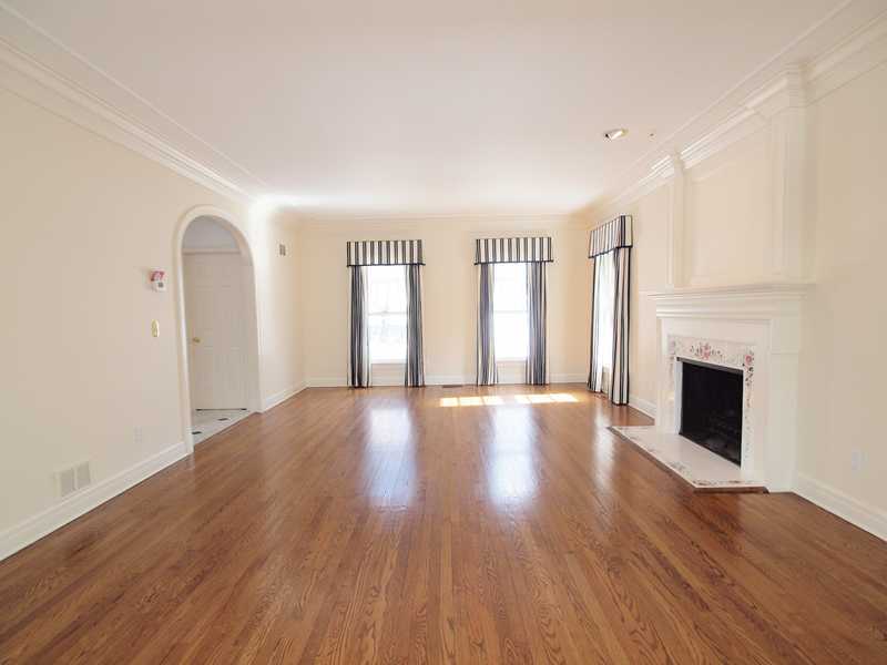Undisclosed Address Darien, CT 06820 - Photo 5 of 19 a view of empty room with wooden floor and fireplace