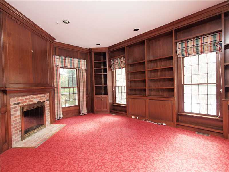 Undisclosed Address Darien, CT 06820 - Photo 10 of 19 an empty room with furniture and a fireplace