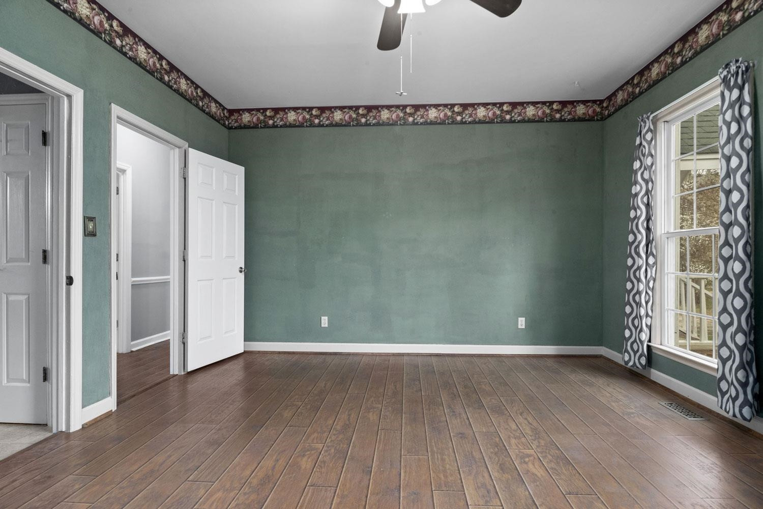 2109 Howson Road Raleigh, NC 27603 - Photo 18 of 36 an empty room with wooden floor and windows