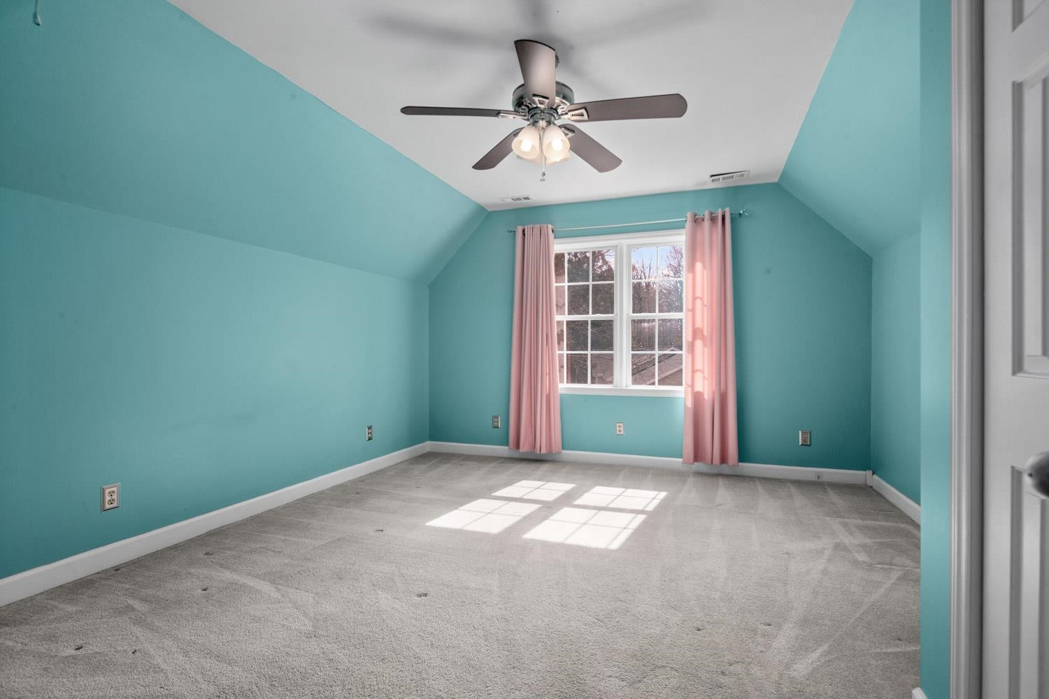 2109 Howson Road Raleigh, NC 27603 - Photo 22 of 36 an empty room with windows and fan