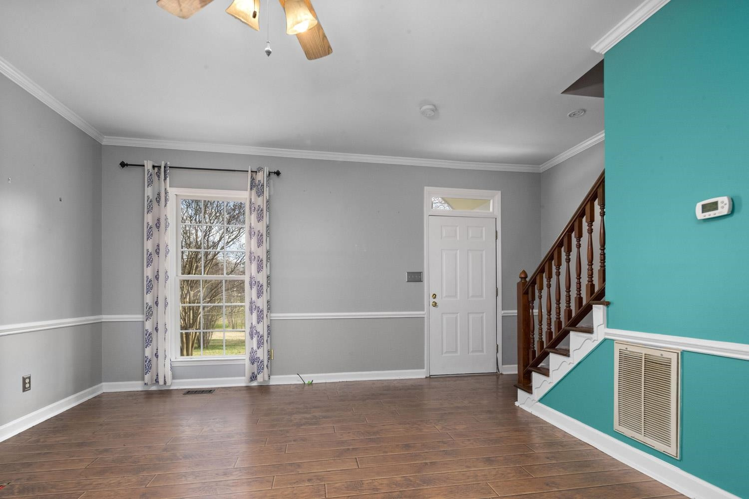 2109 Howson Road Raleigh, NC 27603 - Photo 7 of 36 a view of an empty room with stairs and a window