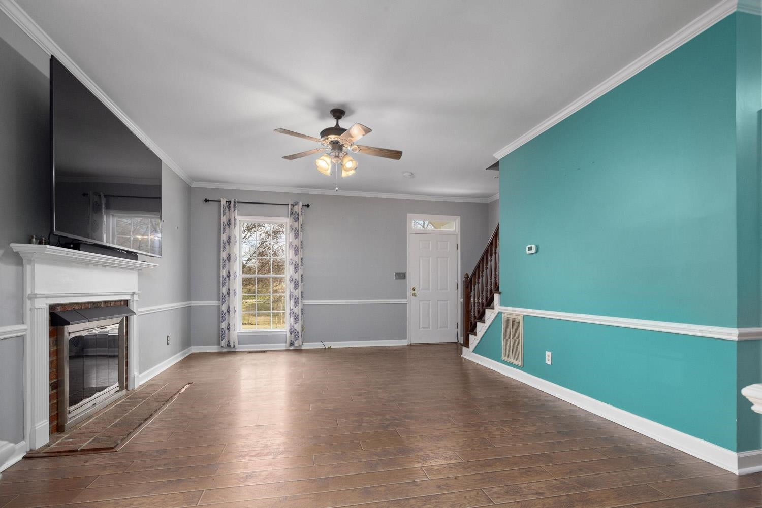 2109 Howson Road Raleigh, NC 27603 - Photo 8 of 36 a view of an empty room with a fireplace and a window