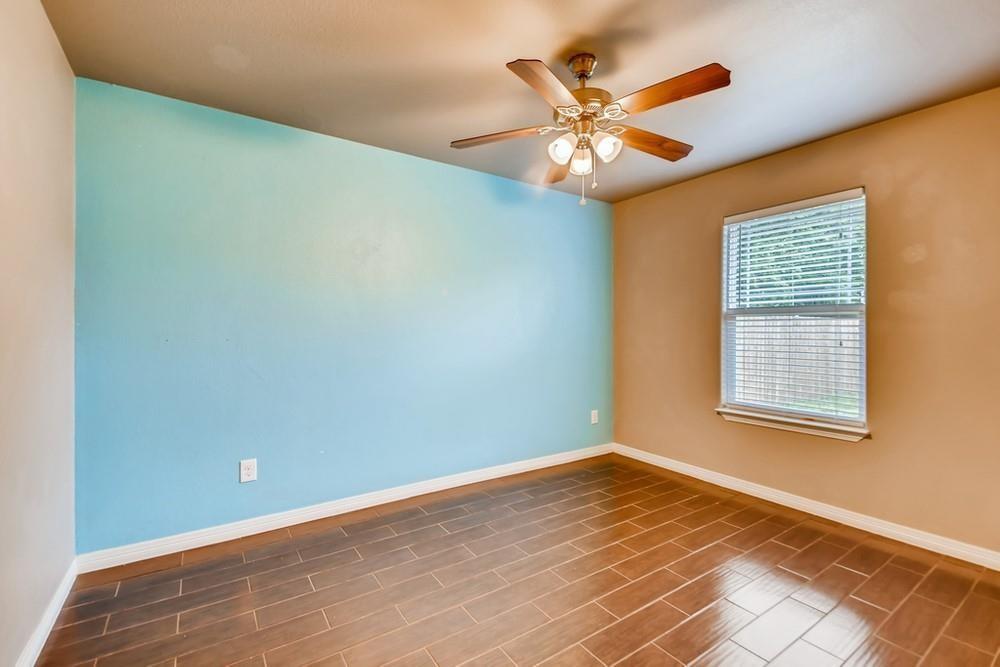 713 Rike Street McKinney, TX 75069 - Photo 16 of 29 an empty room with a window and a ceiling fan