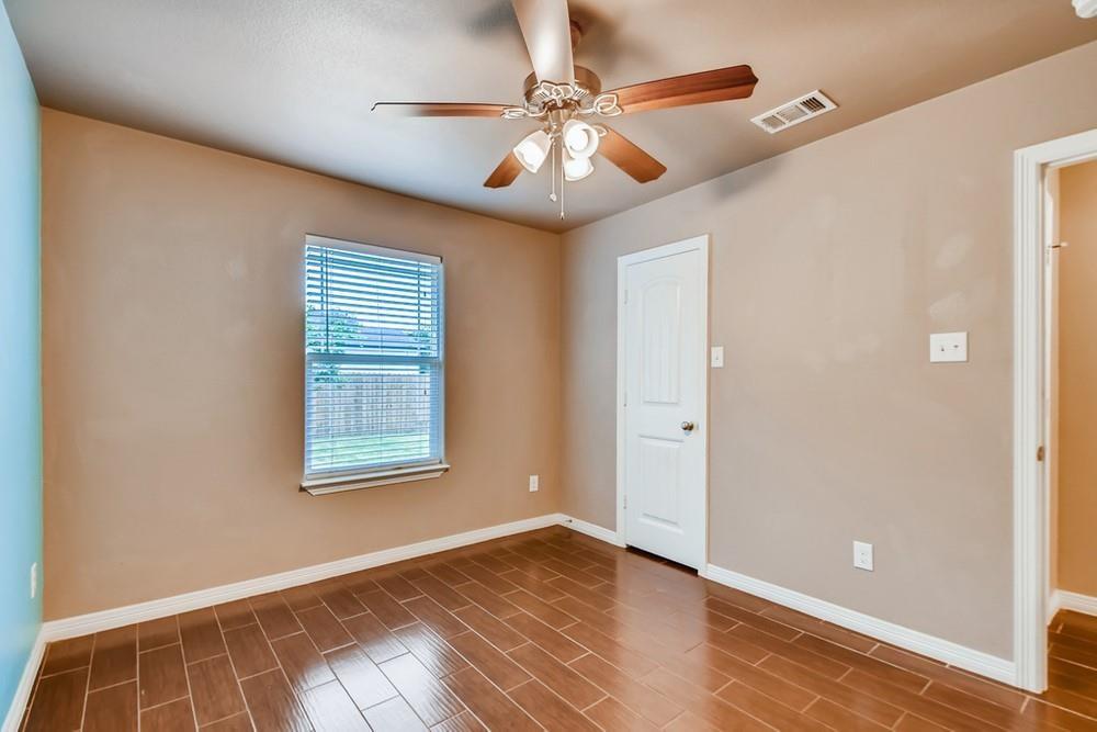 713 Rike Street McKinney, TX 75069 - Photo 17 of 29 a view of an empty room with window and wooden floor
