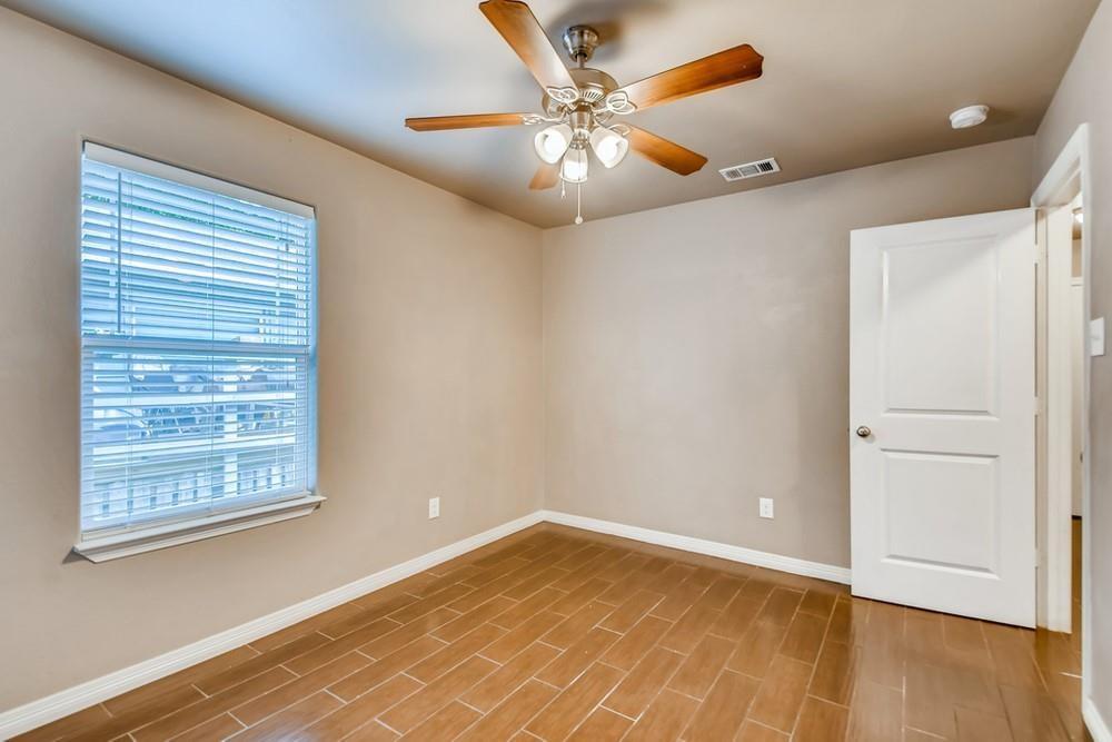 713 Rike Street McKinney, TX 75069 - Photo 18 of 29 a view of an empty room with wooden floor and a window