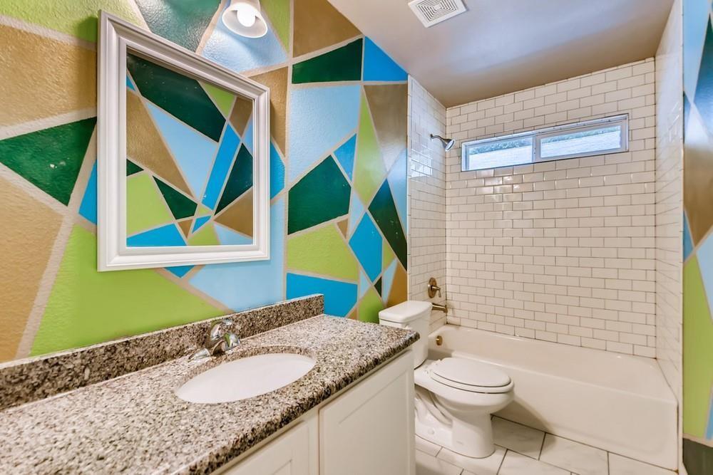 713 Rike Street McKinney, TX 75069 - Photo 19 of 29 a bathroom with a granite countertop toilet sink and mirror